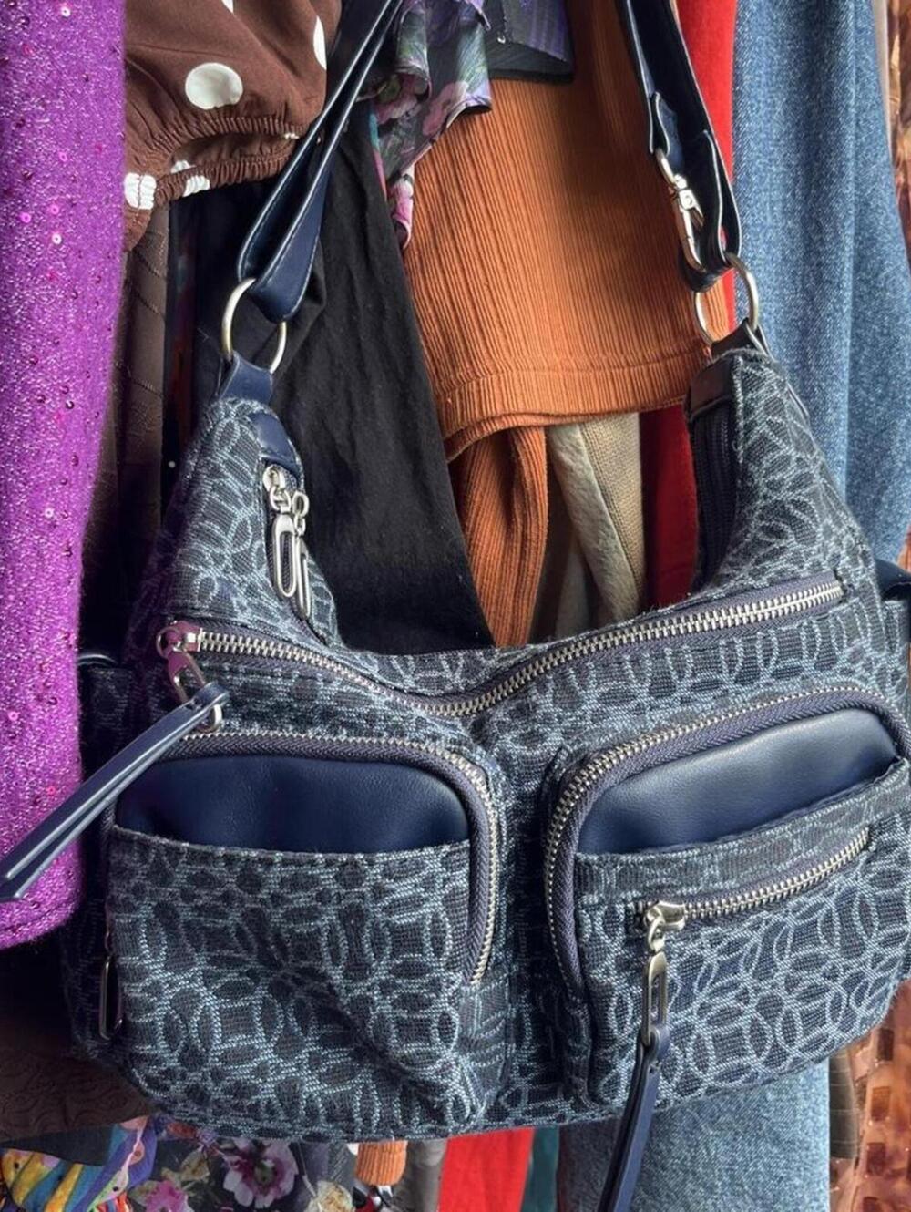 Blue purse with repeating white geometric pattern